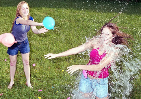 Children playing a water balloon throwing game